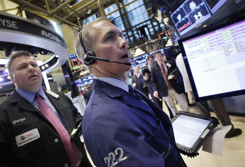 Timothy Nick, center, with Grey Wolf Execution Partners, monitors stock prices at the New York Stock Exchange, Wednesday, Feb. 12, 2014. U.S. stocks are edging higher in early trading as the market extends its longest winning streak of the year. (AP Photo/Mark Lennihan)