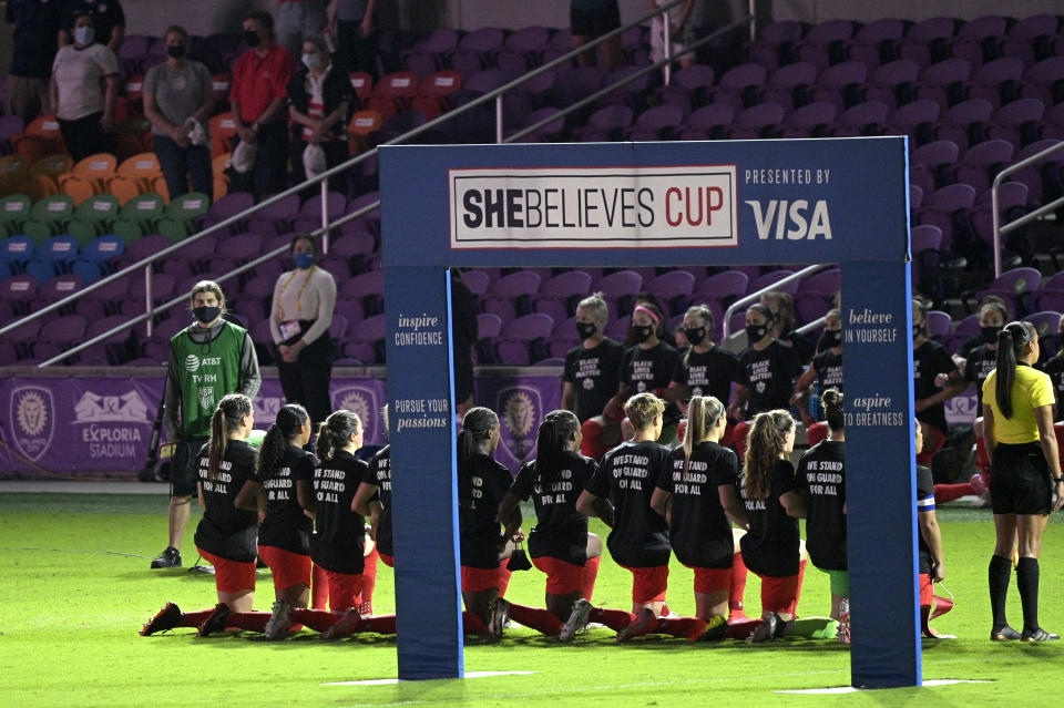 Members of the Canada team kneel and wear Black Lives Matter shirts during the playing of their national anthem before a SheBelieves Cup women's soccer match against the United States, Thursday, Feb. 18, 2021, in Orlando, Fla. (AP Photo/Phelan M. Ebenhack)