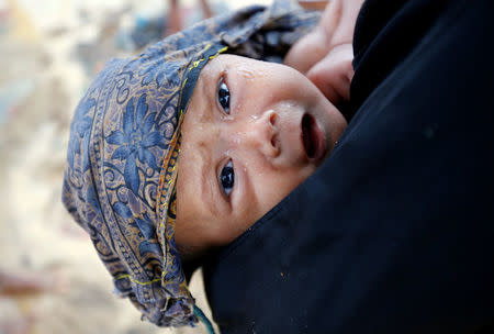 A Rohingya refugee child cries after getting wet in the rain in Cox's Bazar, Bangladesh, September 17, 2017. REUTERS/Mohammad Ponir Hossain