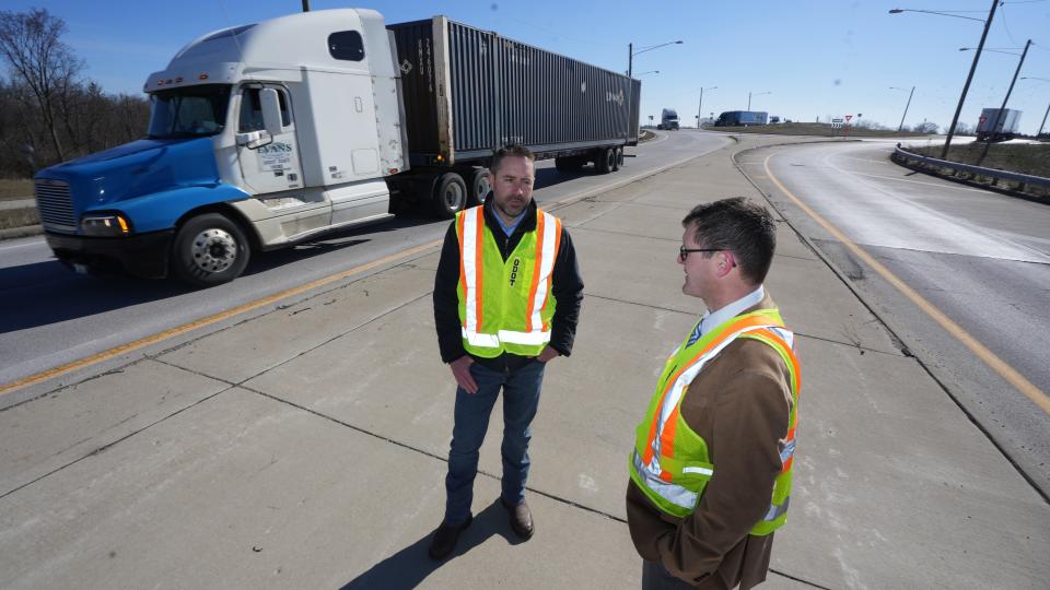 Madison County engineer Bryan Dhume (left) and Toni Turowski of the Ohio Department of Transportation District 6 talk at a new roundabout on State Route 29 at Interstate 70.