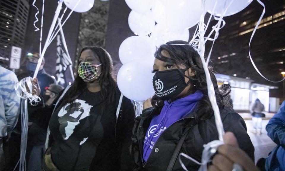 Protesters prepare to release balloons in front of the Hennepin county government center, in a protest calling for justice for George Floyd on 9 April.