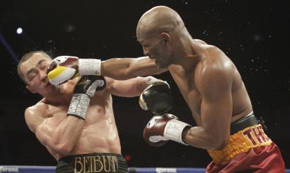 Beibut Shumenov (L) takes a punch from Bernard Hopkins during their IBF, WBA and IBA Light Heavyweight World Championship in April. (AP)