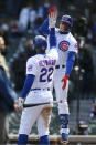 Chicago Cubs Javier Baez, right, celebrates with teammate Jason Heyward, left, after hitting a three-run home run during the third inning of a baseball game against the Atlanta Braves Saturday, April 17, 2021, in Chicago. (AP Photo/Paul Beaty)