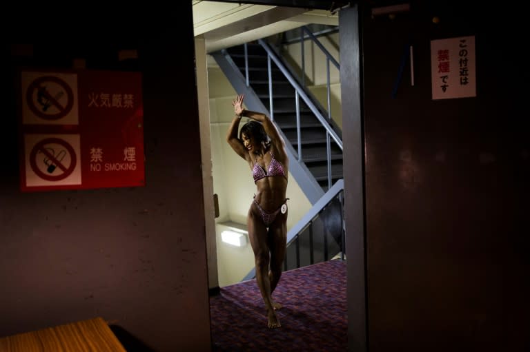 Japanese bodybuilder Miyuki Sato poses as she warms up backstage during the Japan bodybuilding championships in Tokyo