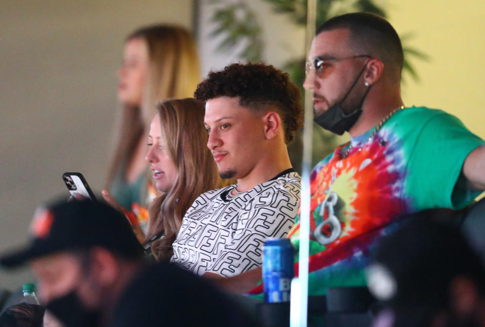 Mar 21, 2021; Phoenix, Arizona, USA; Kansas City Chiefs quarterback Patrick Mahomes (left) alongside teammate Travis Kelce in a suite during the Phoenix Suns game against the Los Angeles Lakers in the first half at Phoenix Suns Arena. Mandatory Credit: Mark J. Rebilas-USA TODAY Sports