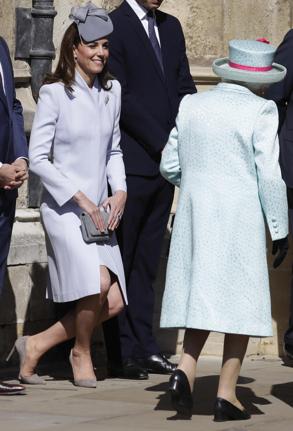 Britain's Kate, The Duchess of Cambridge curtsies as Britain's Queen Elizabeth II arrives to attend the Easter Mattins Service at St. George's Chapel, at Windsor Castle in England Sunday, April 21, 2019. (AP Photo/Kirsty Wigglesworth, pool)