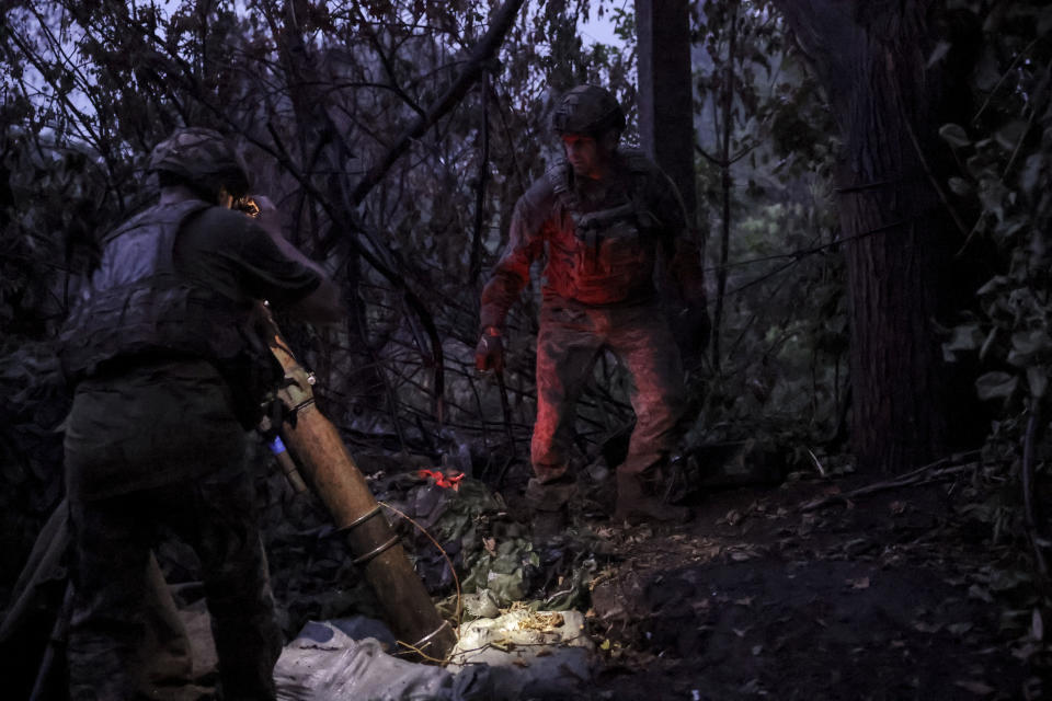 In this photo provided by the 24th Mechanised brigade press service, Ukrainian soldiers fire 120 mm mortar towards Russian position on the front line at Chasiv Yar in Donetsk region, Ukraine, Friday, June 21, 2024. (Oleg Petrasiuk/Ukrainian 24 Mechanised brigade via AP)