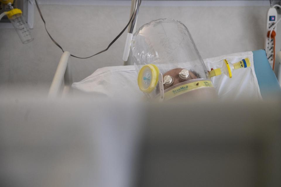 A patient under treatment lies on a bed in the emergency COVID-19 ward at the Mellino Mellini hospital in Chiari, northern Italy, Monday, March 8, 2021. The 160-bed hospital in the Po River Valley town of Chiari has no more beds for patients stricken with the highly contagious variant of COVID-19 first identified in Britain, and which now has put hospitals in Italy’s northern Brescia province on high alert. (AP Photo/Luca Bruno)