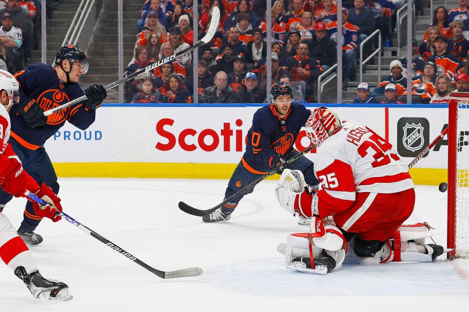 Edmonton Oilers forward Klim Kostin (21) hits the goal post behind Detroit Red Wings goaltender Ville Husso (35) during the first period at Rogers Place in Edmonton on Wednesday, Feb. 15, 2023.