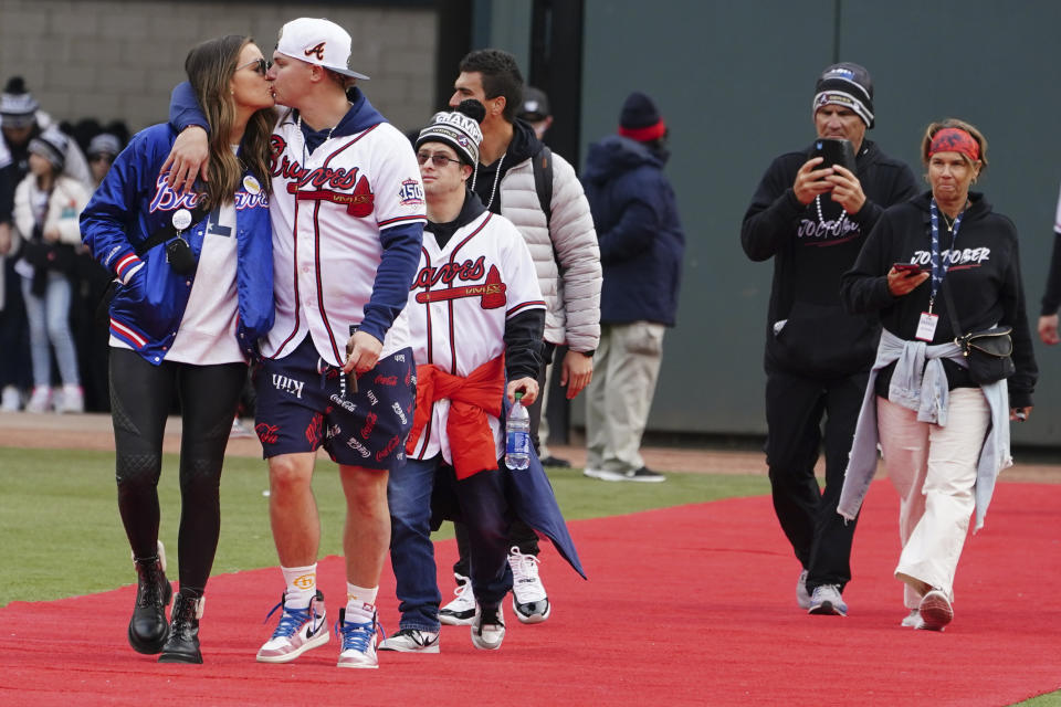 Atlanta Braves' Joc Pederson kisses his wife on the red carpet during a celebration at Truist Park, Friday, Nov. 5, 2021, in Atlanta. The Braves beat the Houston Astros 7-0 in Game 6 on Tuesday to win their first World Series MLB baseball title in 26 years. (AP Photo/John Bazemore)