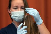 FILE — In this July 27, 2021 file photo, Katrina Taormina draws the Pfizer COVID-19 vaccine into a syringe at Lehman High School, in New York. New York Gov. Andrew Cuomo and New York City Mayor Bill de Blasio have scheduled competing news conferences Monday, Aug. 2 amid rising COVID-19 case counts attributed to the highly contagious delta variant of the virus. (AP Photo/Mark Lennihan, File)