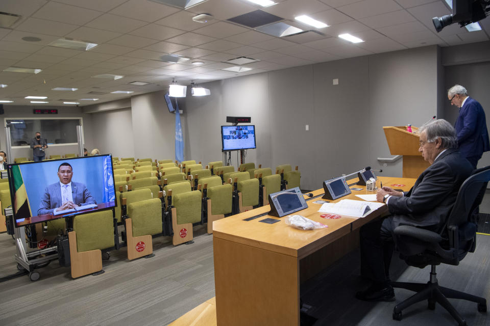 In this photo provided by the United Nations, Secretary-General Antonio Guterres, second from right, briefs reporters during the 75th session of the United Nations General Assembly, Tuesday, Sept. 29, 2020, at UN headquarters in New York. (Eskinder Debebe/UN Photo via AP)