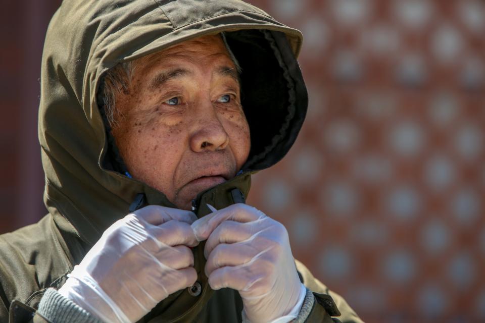 Ben Barcelona suits up in a parka and rubber gloves — DIY protective gear against the coronavirus — readying for a walk through Koreatown to his daughter's apartment on his 81st birthday.