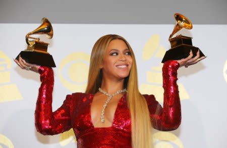 FILE PHOTO: Beyonce holds the awards she won for Best Urban Contemporary Album for