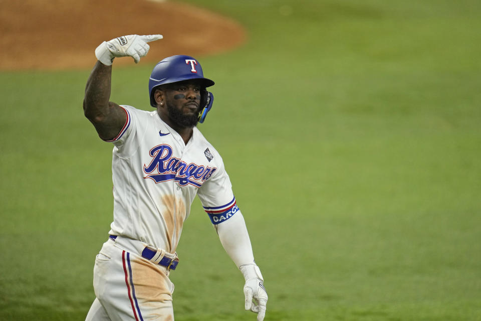 Texas Rangers' Adolis Garcia celebrates after hitting a game-winning home run against the Arizona Diamondbacks during the 11th inning in Game 1 of the baseball World Series Friday, Oct. 27, 2023, in Arlington, Texas. The Rangers won 6-5. (AP Photo/Julio Cortez)