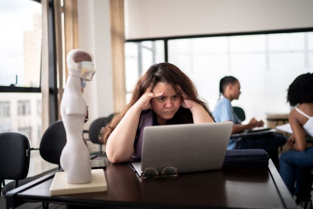 Displeased teacher working using laptop in the classroom (Photo: FG Trade via Getty Images)