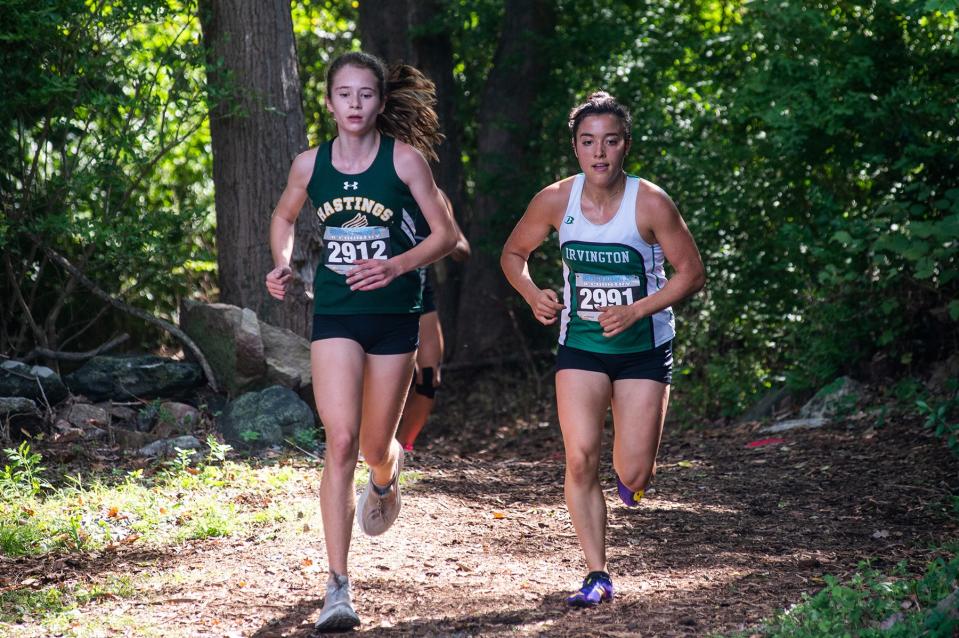 Hastings' Caitlin Thomas, left, and Irvington's Luciana Forte, right, compete in the girls division 3 race during the Somers Big Red Cross Country Invitational at Somers High School in Lincolndale on Saturday, September 10, 2022.