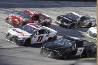 Racers Denny Hamlin (11), Kyle Busch (18), Aric Almirola (10) and Joey Gase (51) speed through a turn during a NASCAR Cup Series auto race at Bristol Motor Speedway Sunday, May 31, 2020, in Bristol, Tenn. (AP Photo/Mark Humphrey)