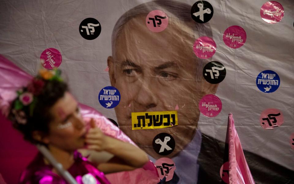 A protest against Mr Netanyahu outside his official residence in Jerusalem this June. The Hebrew reads: "You failed", "Israel free" and "Leave". - Ariel Schalit /AP