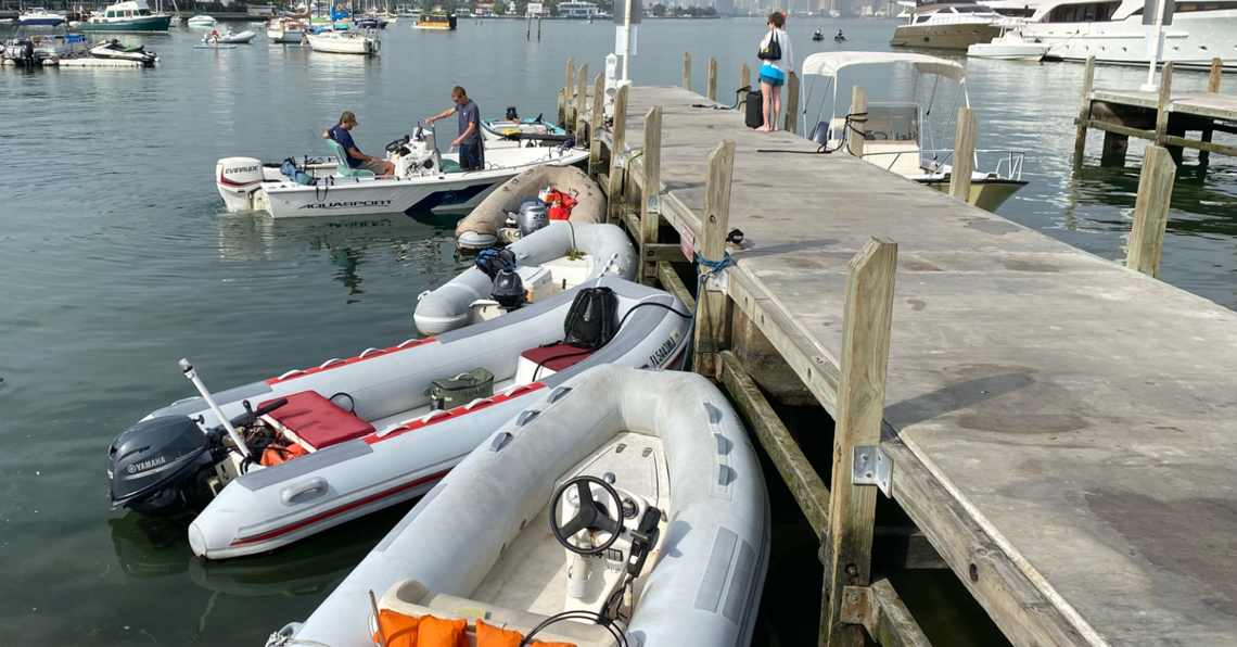 Dinghies and other small boats dock at a boat ramp at Maurice Gibb Memorial Park.