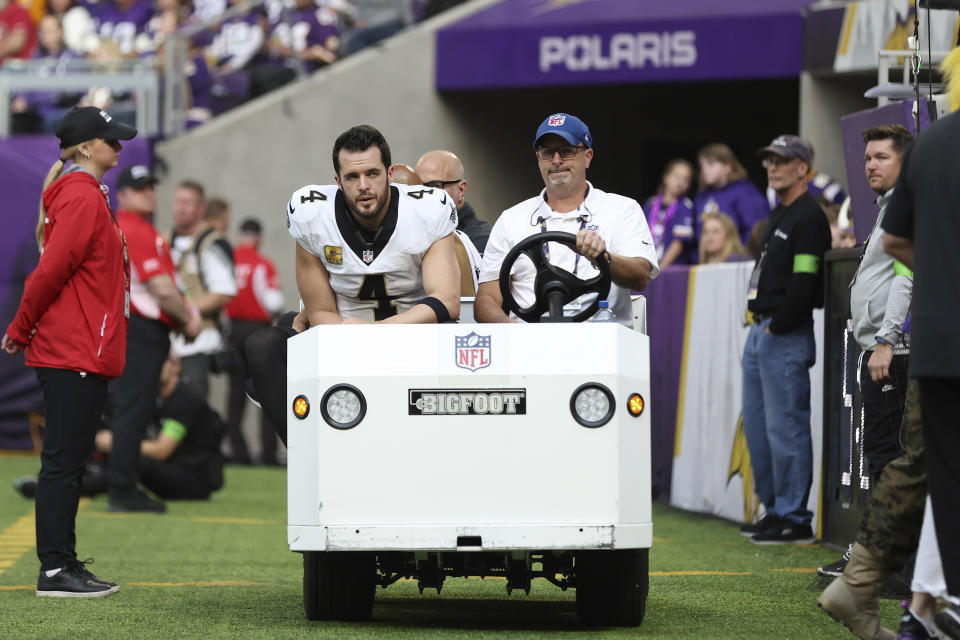 New Orleans Saints quarterback Derek Carr (4) is carted off the field during the second half of an NFL football game against the Minnesota Vikings Sunday, Nov. 12, 2023, in Minneapolis. (AP Photo/Matt Krohn)