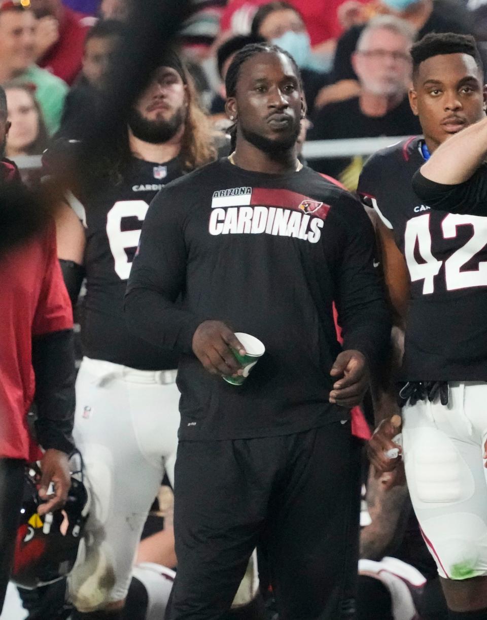 Aug 21, 2022; Glendale, Ariz., United States;  Arizona Cardinals linebacker Markus Golden watches his team play against the Baltimore Ravens during the second quarter in preseason action at State Farm Stadium.