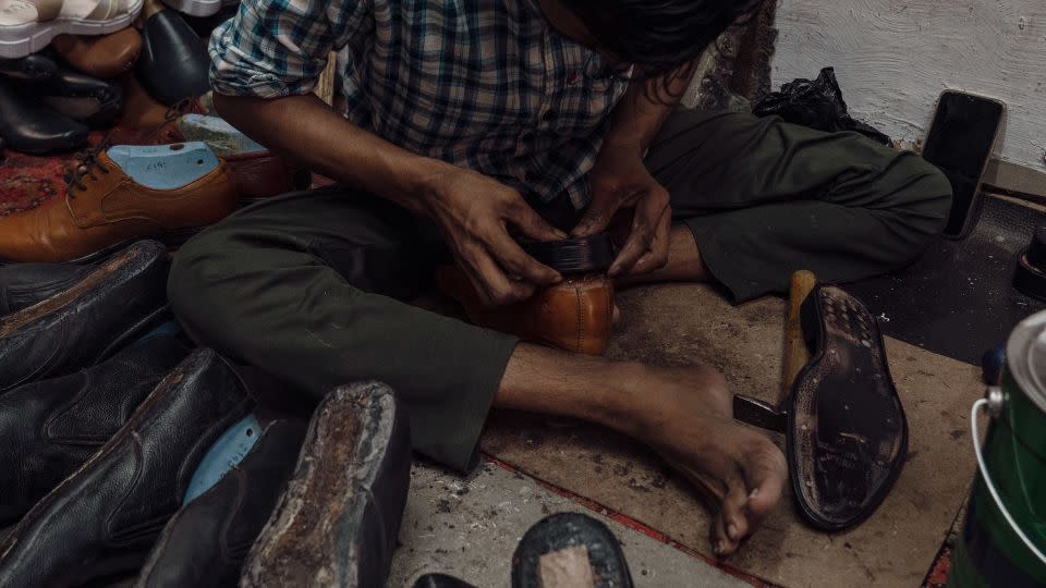 A man works at Shaikh’s workshop in Dharavi slum on April 14. - Noemi Cassanelli/CNN