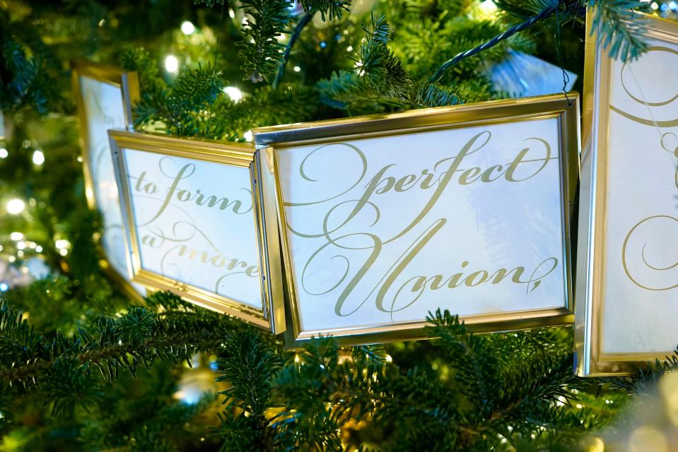 Framed segments of the Preamble to the U.S. Constitution decorate a tree in the Grand Foyer of the White House during a press preview of holiday decorations at the White House, Monday, Nov. 28, 2022, in Washington. (AP Photo/Patrick Semansky)