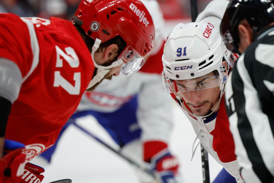 Montreal Canadiens center Sean Monahan (91) and Detroit Red Wings center Michael Rasmussen (27) gets set to face off in the third period at Little Caesars Arena in Detroit on Thursday, Nov. 9, 2023.