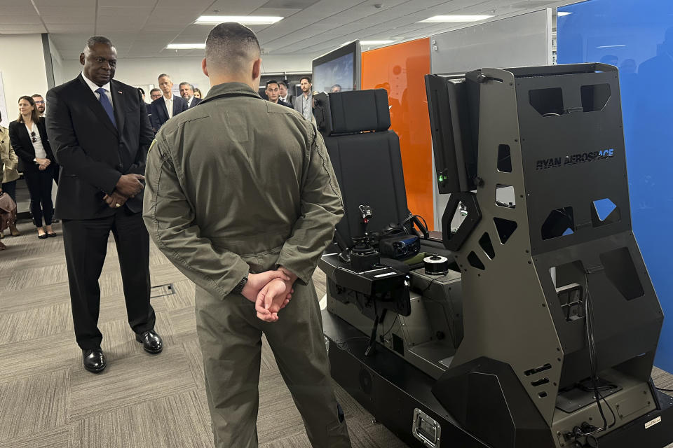 Defense Secretary Lloyd Austin watches a demonstration of a virtual training device that will help Ukrainian pilots learn to fly F-16 fighter jets during a tour of the Pentagon's Defense Innovation Unit in Mountain View, Calif, on Friday, Dec. 1, 2023. (AP Photo/Lolita Baldor)