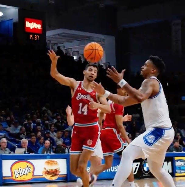 Bradley Braves forward Malevy Leons tries to defend under the basket against Darnell Brodie during BU's 74-66 loss to Drake at Knapp Center in an MVC regular-season finale on Sunday, March 3, 2024.