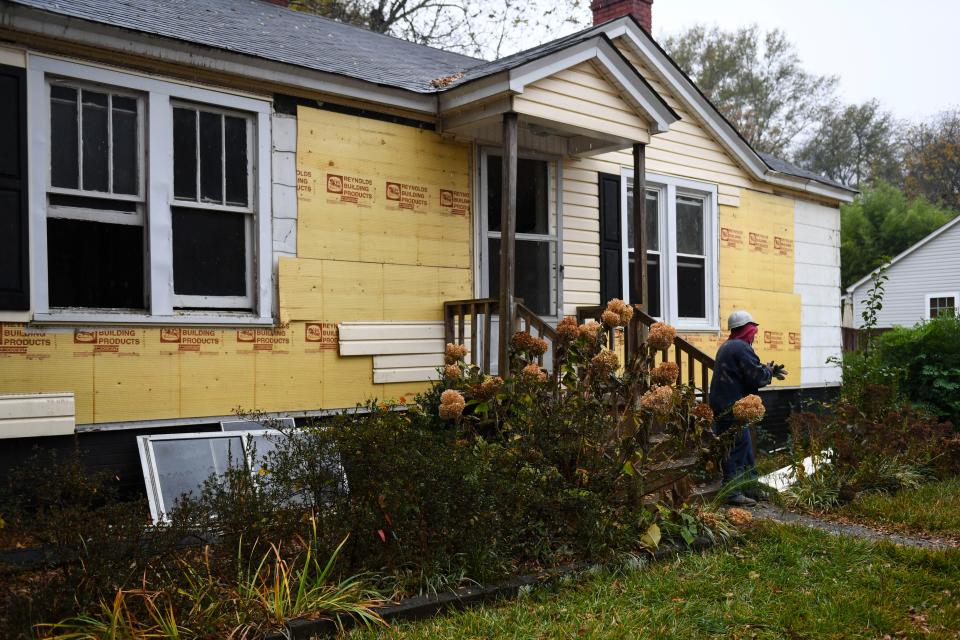 Mike Gambrell, 59, works to reclaim wood from a house on Tuesday, Nov. 21, 2023. Soteria at Work, a work program through Soteria Community Development Corporation, will reuse wood and other pieces of the house that would otherwise be demolished and put into a landfill.