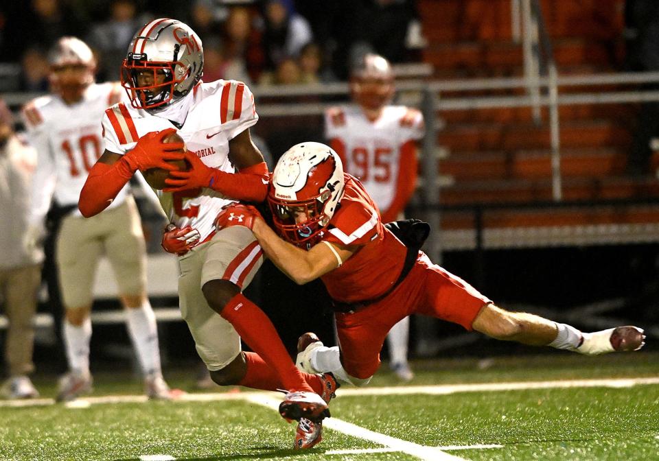 Milford's Aidan Watson tackles Catholic Memorial's Jaedn Skeete s during the the Div. 2 football state semifinal at Bridgewater Raynham Regional High School, Nov. 19, 2022.