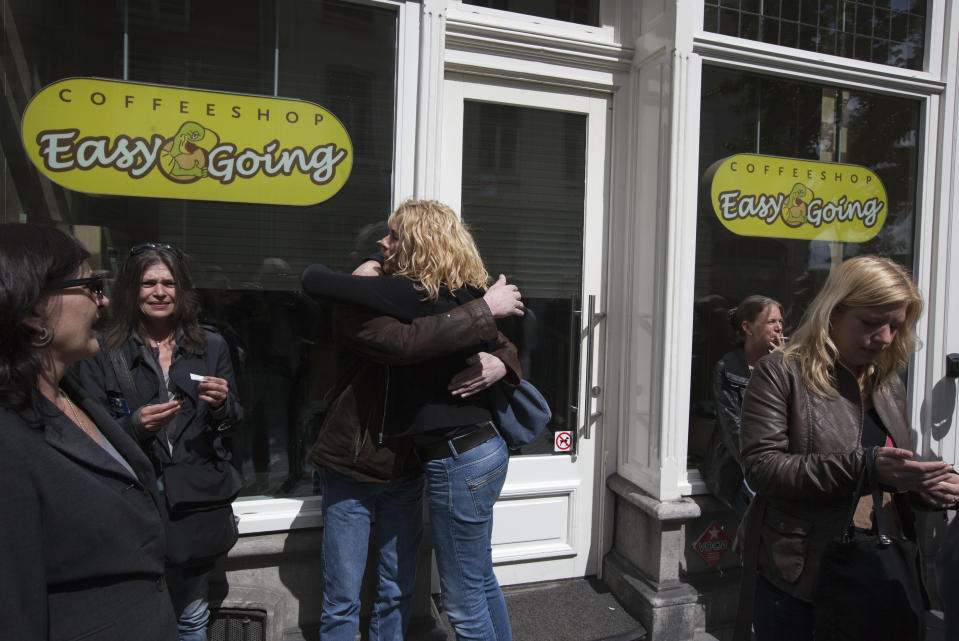 People are seen outside closed coffeeshop Easy Going in Maastricht, southern Netherlands, Tuesday May 1, 2012. A policy barring foreign tourists from buying marijuana in the Netherlands goes into effect in parts of the country Tuesday, with a protest planned in the southern city of Maastricht. Easy Going first refused foreigners entry to provoke a complaint for discrimination, to later sell marijuana to foreigners to provoke a police reaction. Laster it closed its doors as all other coffeeshops in Maastricht were closed. (AP Photo/Peter Dejong)