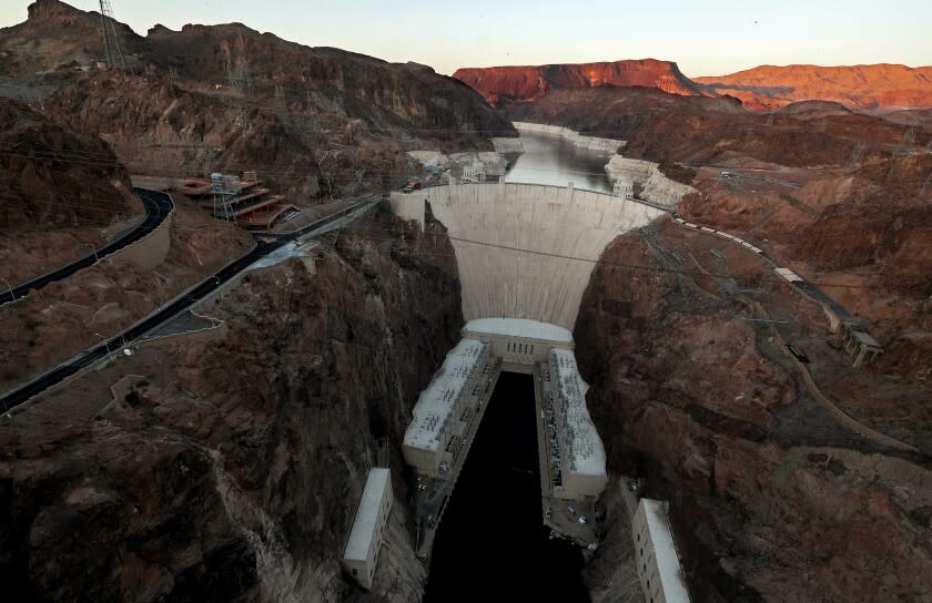BOULDER CITY, NEV. - MAY 16, 2022. The Hoover Dam stands in front of Lake Mead, where white surfaces on the lake's rocky edges show how low water levels have dropped due to persistent and worsening drought conditions for more than a decade. With a current level of about 1,055 feet, Lake Mead is at its lowest point in history even as its continues to supply water to more than 20 people in the lower basin of the Colorado River. With little snowmelt and rain flowing into the lake, the historic dam's hydroelectric generating machinery could become obsolete. (Luis Sinco / Los Angeles Times)