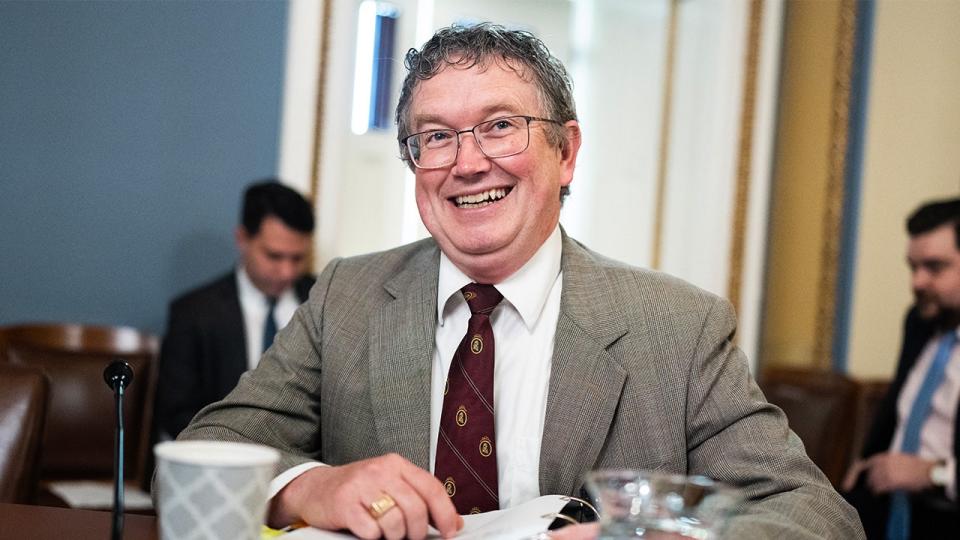 Rep. Thomas Massie smiles in a committee hearing room