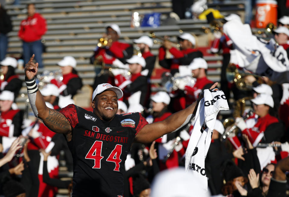 San Diego State linebacker Kyahva Tezino (44) celebrates after his team beat Central Michigan in the New Mexico Bowl NCAA college football game on Saturday, Dec. 21, 2019 in Albuquerque, N.M. (AP Photo/Andres Leighton)