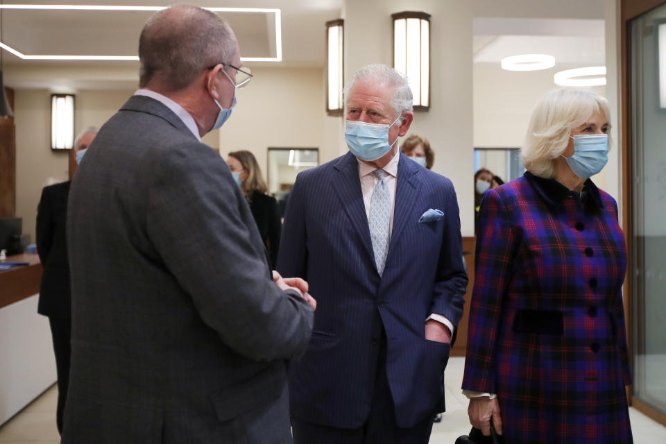 BIRMINGHAM, ENGLAND - FEBRUARY 17: Prince Charles, Prince of Wales and Camilla, Duchess of Cornwall speaks to members of staff during a visit to The Queen Elizabeth Hospital on February 17, 2021 in Birmingham, England. (Photo by Molly Darlington - WPA Pool/Getty Images)
