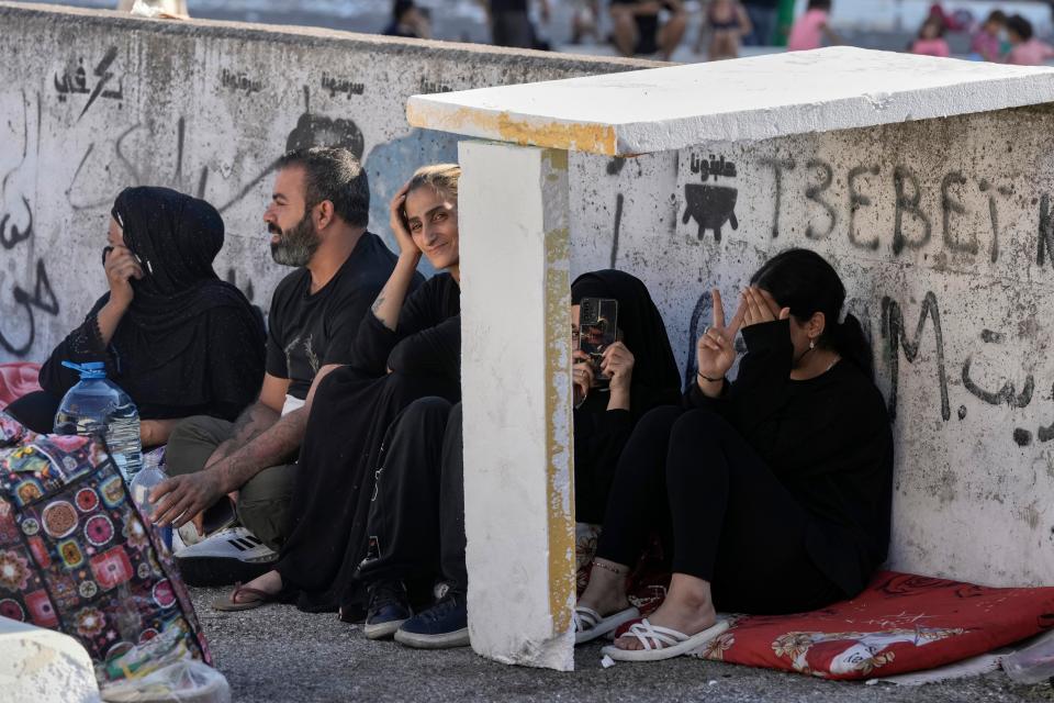 Families sit on the ground in Martyrs' square after fleeing the Israeli airstrikes in Beirut's southern suburb (Copyright 2024 The Associated Press. All rights reserved)