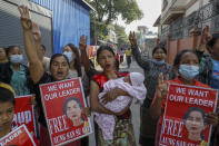 Demonstrators display pictures of deposed Myanmar leader Aung San Suu Kyi during a protest against the military coup in Mandalay, Myanmar, Wednesday, Feb. 17, 2021. The U.N. expert on human rights in Myanmar warned of the prospect for major violence as demonstrators gather again Wednesday to protest the military's seizure of power. (AP Photo)