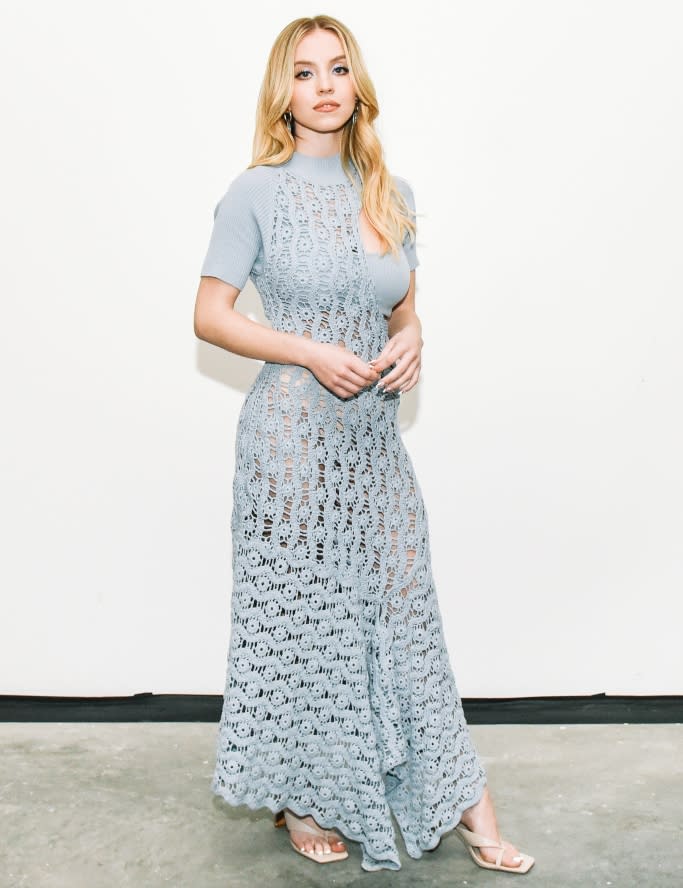 Sydney Sweeney shows off a semi-sheer powder blue dress and nude thong sandals on Dec. 16, 2021. - Credit: Images courtesy of BFA/Linnea Stephan