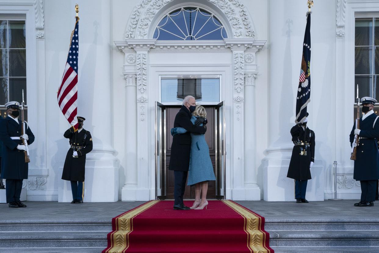 President Joe Biden and first lady Jill Biden hug as they arrive at the North Portico of the White House, Wednesday, Jan. 20, 2021, in Washington.