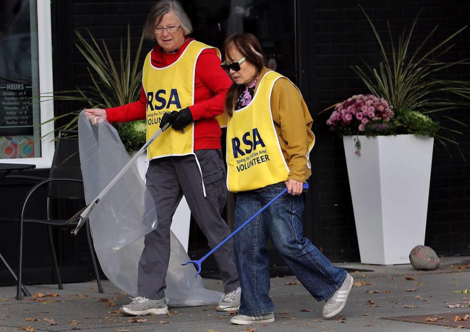 Lucy Rademacher, left, and Eva Elwell, both Richland Seniors Association volunteers, team up to pick up trash from the retail area of the Richland Parkway. Elwell moved to Richland in 1993 from Los Angeles for her husband’s work. Originally from Taiwan, she’s stayed for the weather, rivers and mountains.