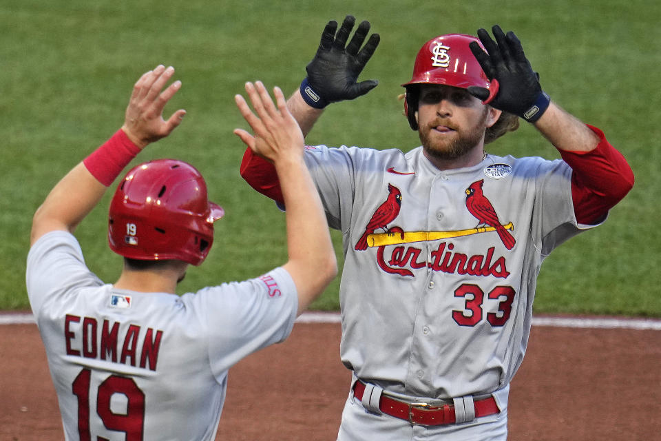 St. Louis Cardinals' Brendan Donovan (33) celebrates with Tommy Edman as he returns to the dugout after hitting a two-run home run off Pittsburgh Pirates starting pitcher Roansy Contreras during the third inning of a baseball game in Pittsburgh, Friday, June 2, 2023. (AP Photo/Gene J. Puskar)
