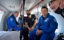 NASA astronauts Douglas Hurley and Robert Behnken prepare to depart their helicopter at Naval Air Station Pensacola after the duo landed in their SpaceX Crew Dragon Endeavour spacecraft in the Gulf of Mexico off the coast of Pensacola, Florida