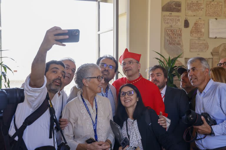 New Cardinal Américo Manuel Alves Aguiar, auxiliary bishop of Lisbon, poses for a selfie photo with journalists at the end of the consistory where Pope Francis elevated 21 new cardinals in St. Peter's Square at The Vatican, Saturday, Sept. 30, 2023. (AP Photo/Riccardo De Luca)