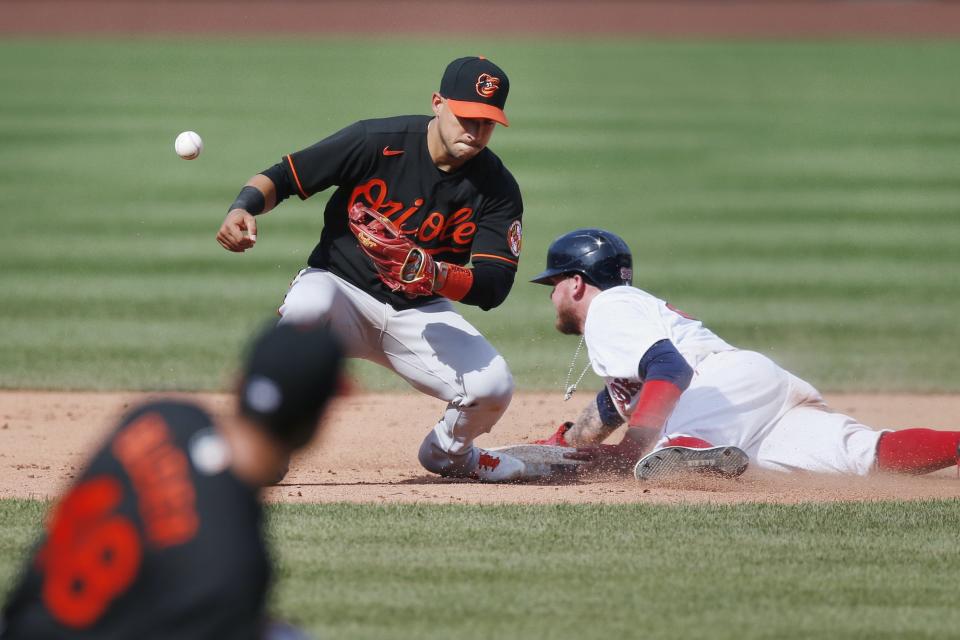 Boston Red Sox's Alex Verdugo, right, advances to second base as Baltimore Orioles' Jose Iglesias cannot handle the throw after a wild pitch by Orioles' Richard Bleier during the eighth inning of a baseball game Saturday, July 25, 2020, in Boston. (AP Photo/Michael Dwyer)