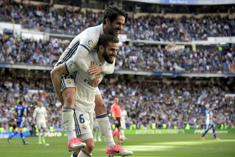 Real Madrid's defender Nacho Fernandez celebrates a goal with midfielder Isco during a Spanish league football match against Deportivo Alaves at the Santiago Bernabeu stadium in Madrid on April 2, 2017