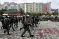 Riot police officers patrol Wong Tai Sin district during an anti-government protests in Hong Kong