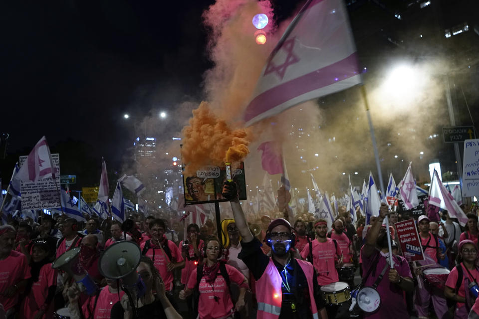 Israelis protest against plans by Prime Minister Benjamin Netanyahu's government to overhaul the judicial system, in Tel Aviv, Israel, Saturday, April 8, 2023. (AP Photo/Ariel Schalit)